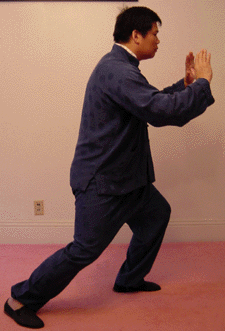 Shift the body's weight onto the left foot and at the same time, push both hands forward with the palms face forward